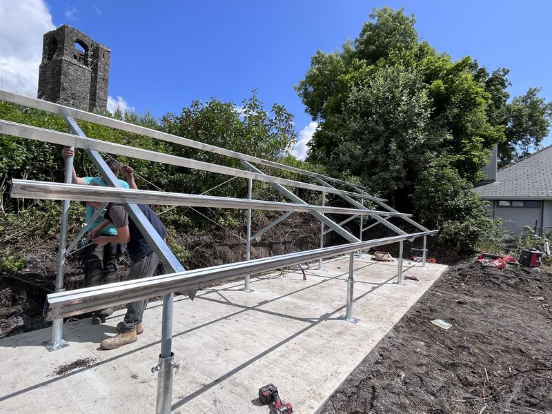 Installation crew building a galvanised ground mount solar frame in Ireland